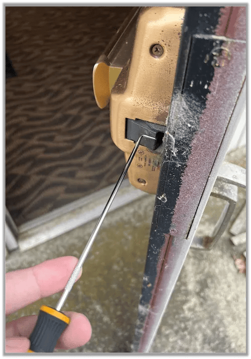 Using a shrum tool to push open a door latch