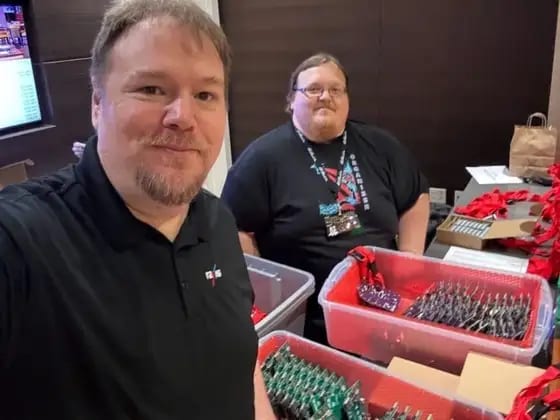 Jason with his friend Daniel handing out badges at OzSec 2024