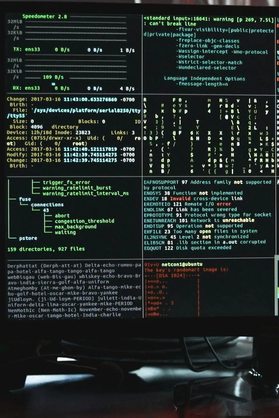 Close-up of a computer monitor displaying cyber security data and code, indicative of system hacking or programming.