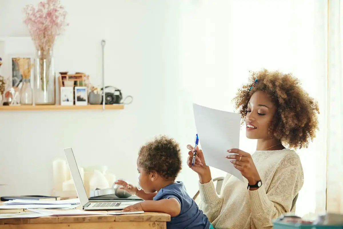 Working mom with small child in her lap