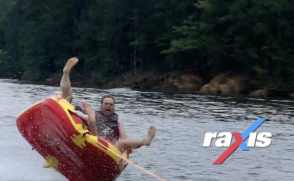 raxis team members at the lake, about to fall out of a tube