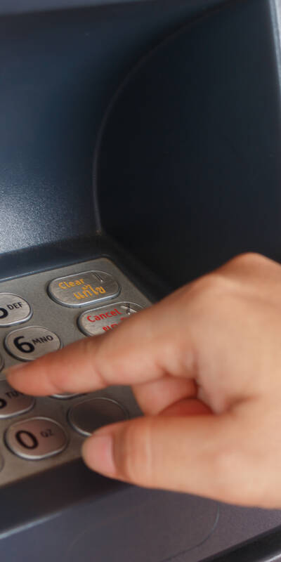 Close up as a woman entering her pin at the ATM