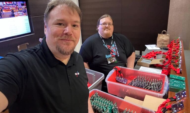 Jason with his friend Daniel handing out badges at OzSec 2024