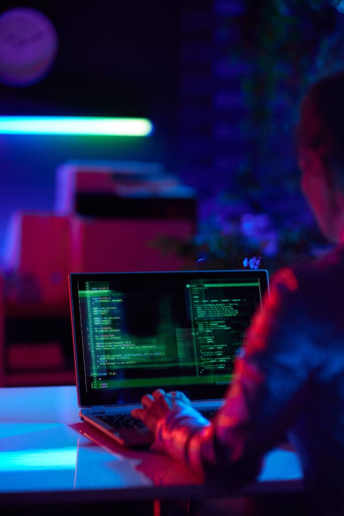 Red team engineer working on computer with red and blue tint