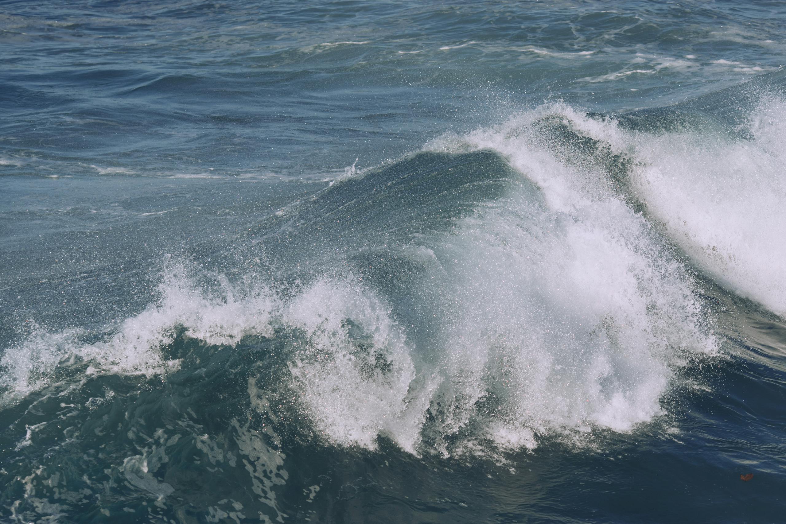 Powerful ocean waves crashing with splashes of foam creating a dynamic seascape.