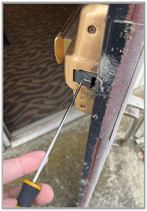 Using a shrum tool to push open a door latch