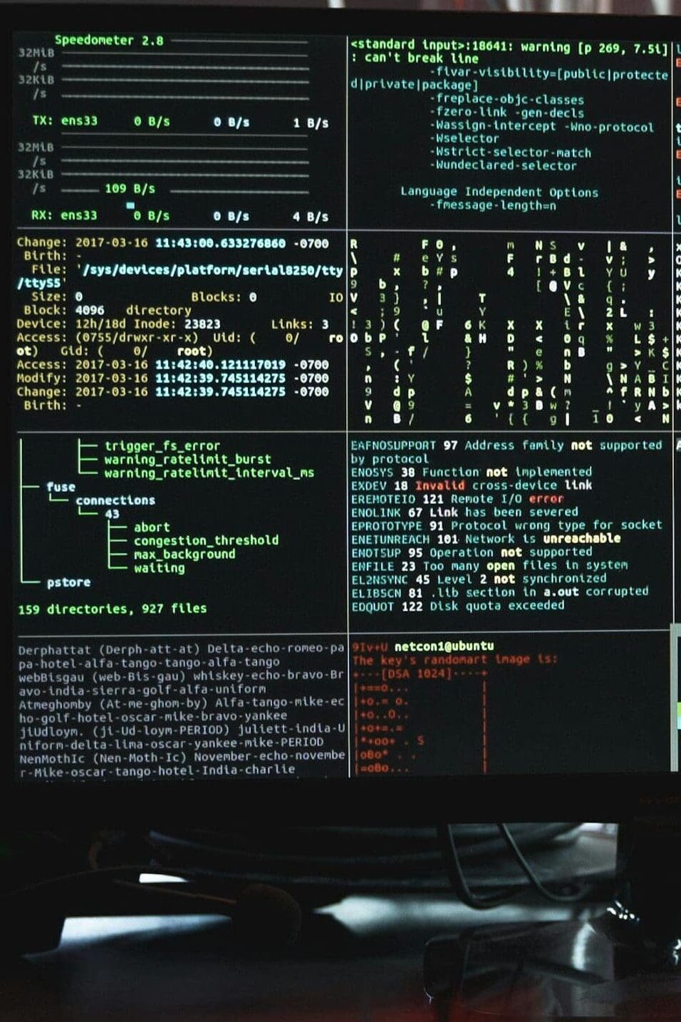Close-up of a computer monitor displaying cyber security data and code, indicative of system hacking or programming.